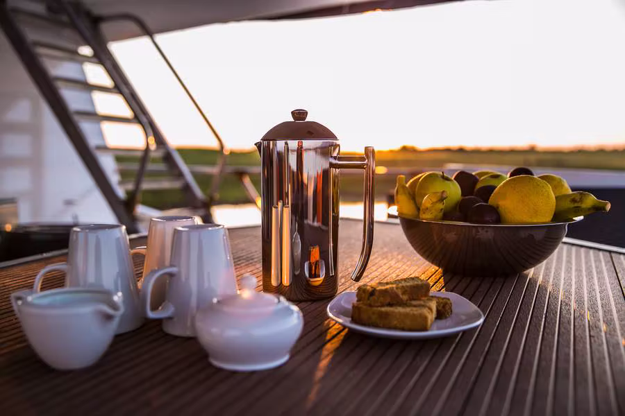 Coffee, fruit and pastries laid out on deck