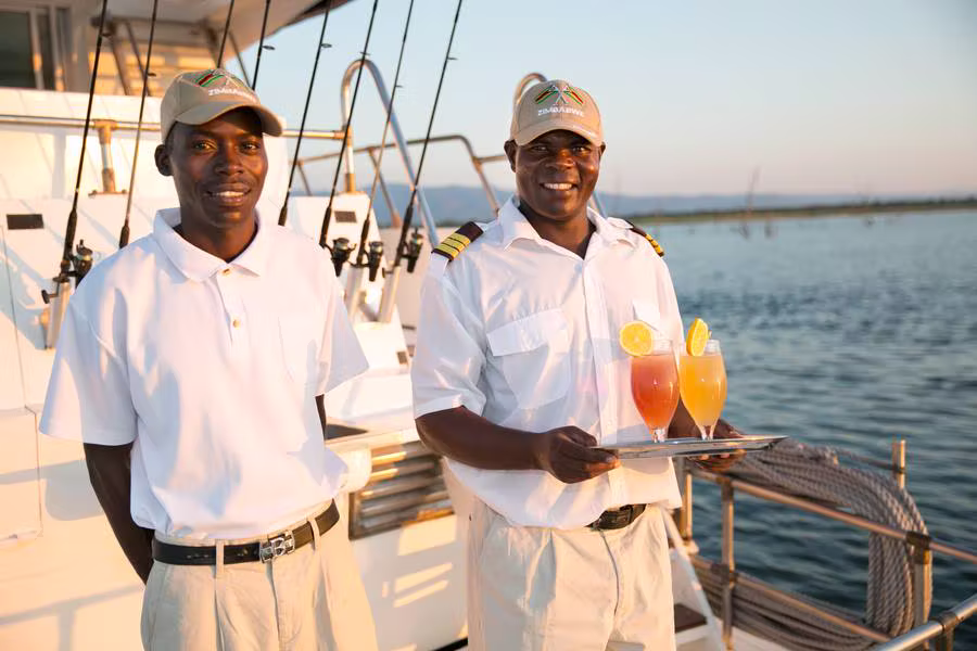 Corsaro's crew on the stern with welcome drinks