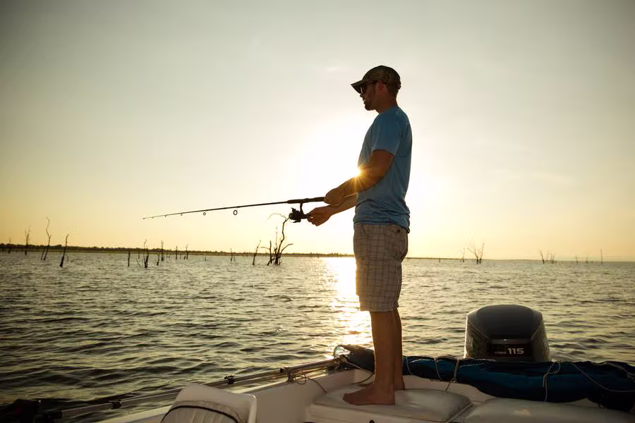 A guest fishing from a tender at sunset