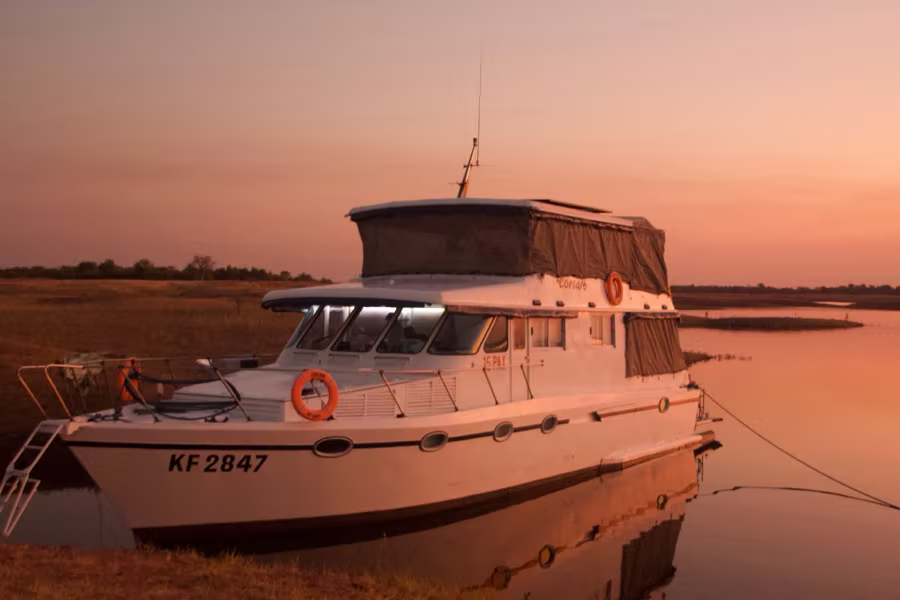 Corsaro moored at dusk with the deck nets rolled down