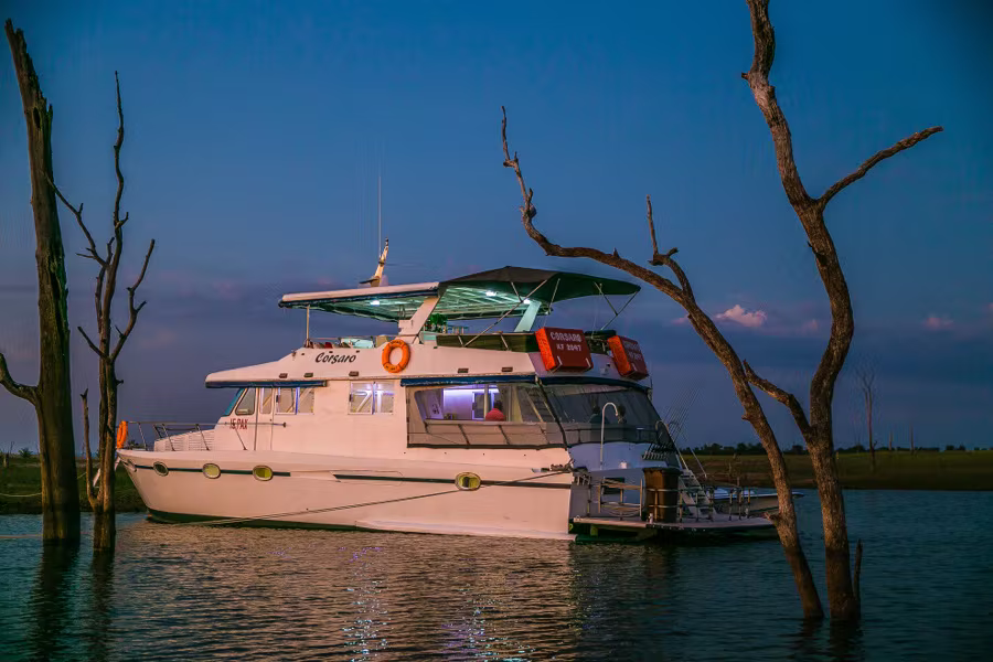 Corsaro lit up at dusk among the drowned trees