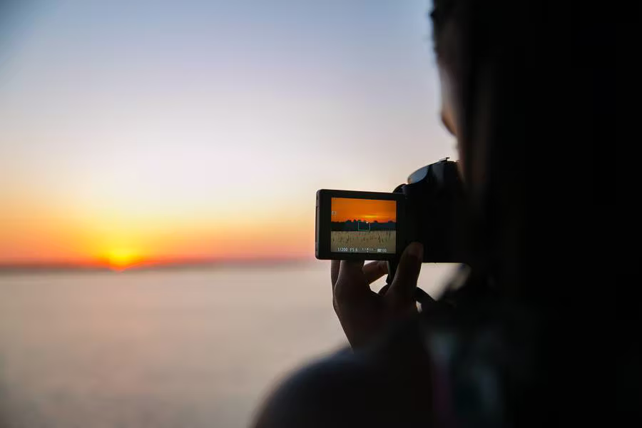 A guest filming the sunset over the lake